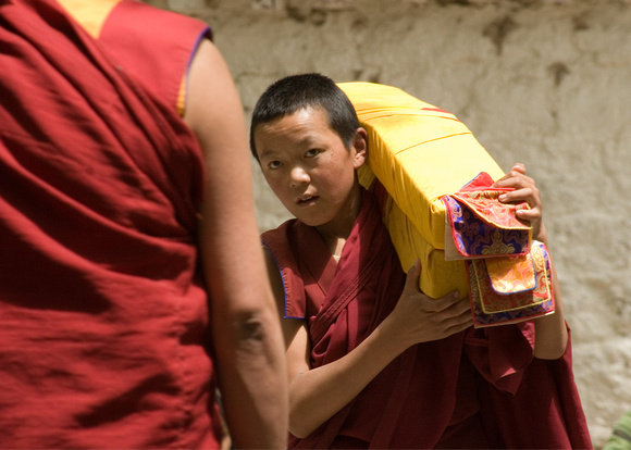 Young Monk carrying prayer books